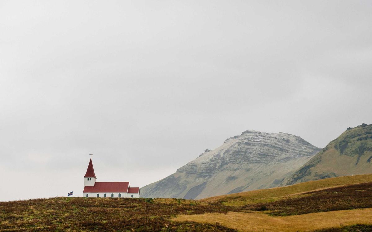 Iceland church with mountains in the background